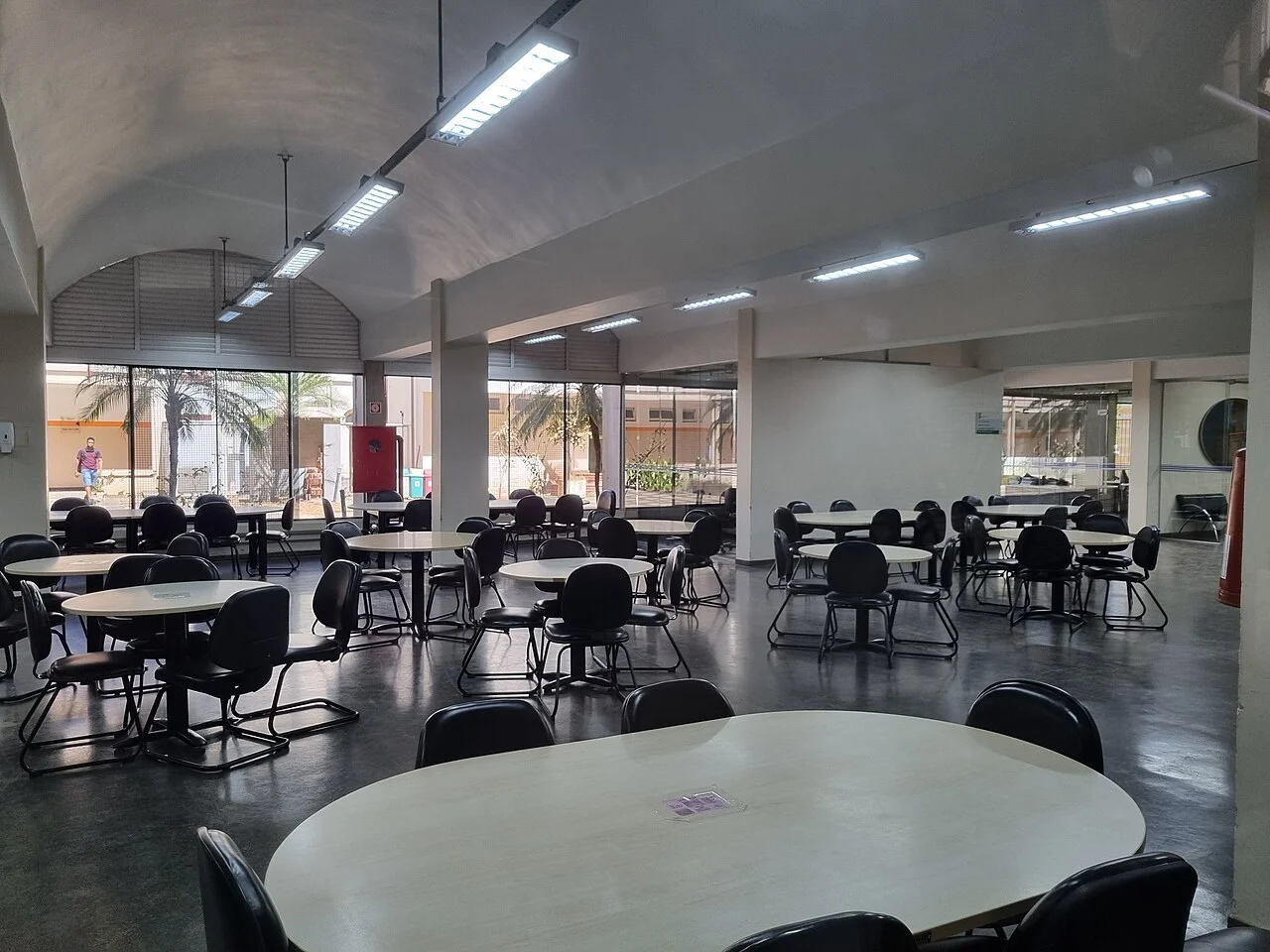 Sala de estudos e biblioteca com mesas individuais de concentração para concurseiros